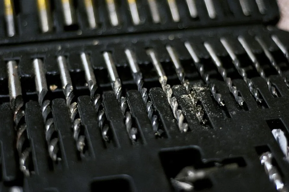 Set of drill bits and driver bits in a case